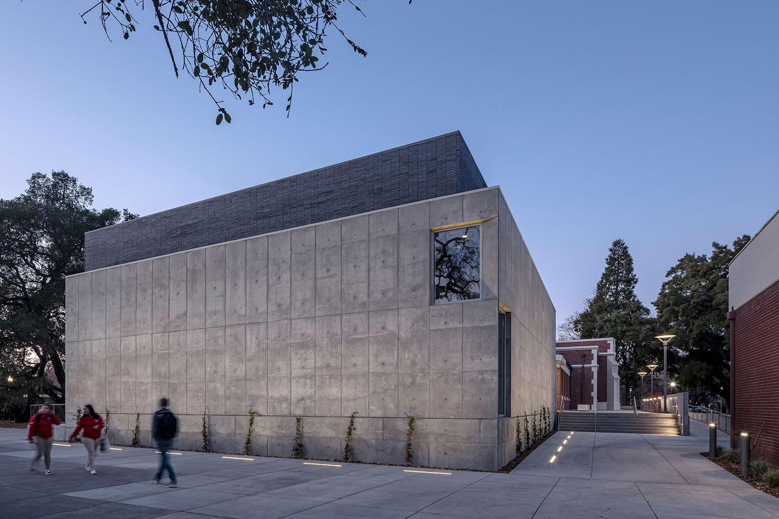 SRJC Burbank Auditorium night view of new contemporary addition set against original brick theater