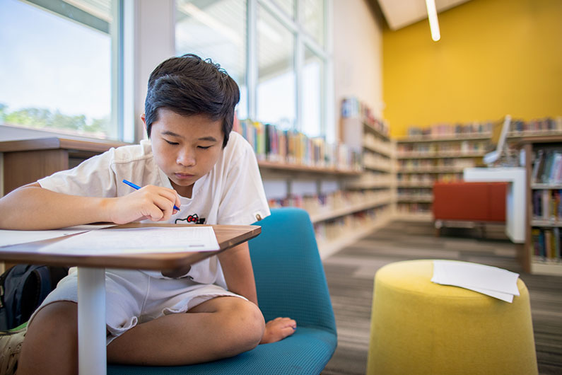 Male student working at desk in Learning Resource Center