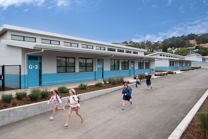 Kids running by classroom building at Irene Snow Elementary