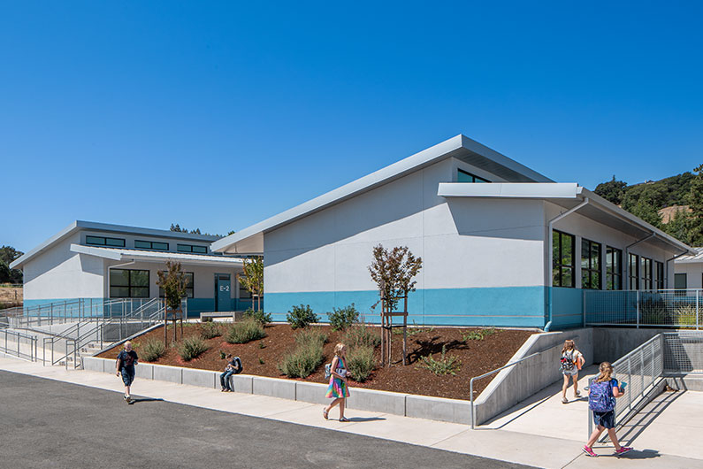 Exterior view of two classrooms at Irene Snow Elementary with kids walking by