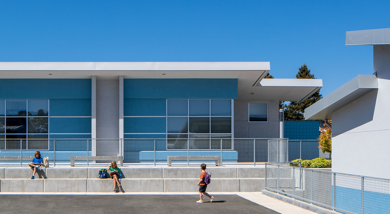 3 kids using outdoor seating at Irene Snow Elementary