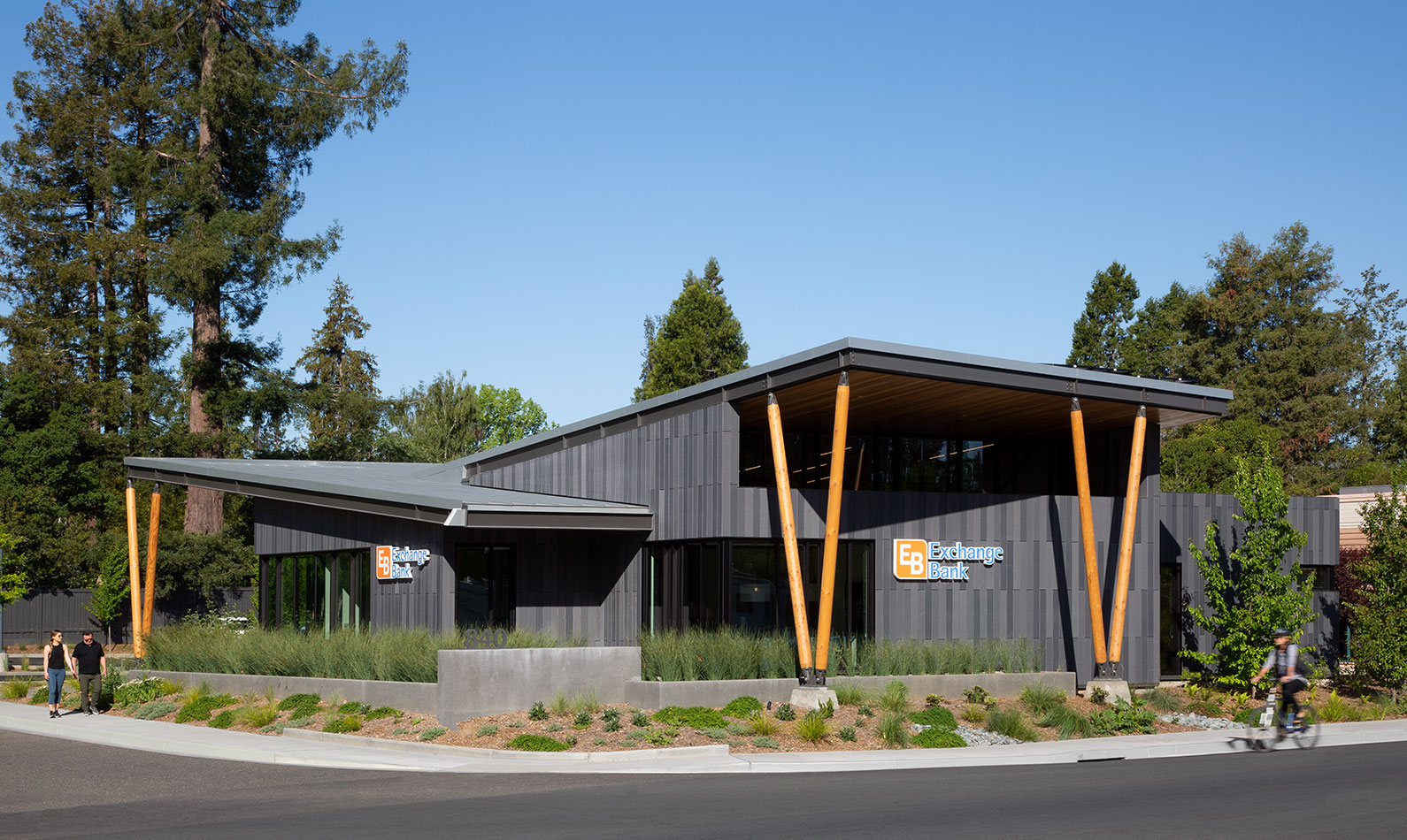 Corner view of Exchange Bank's Sebastopol Branch with people walking and bicycling