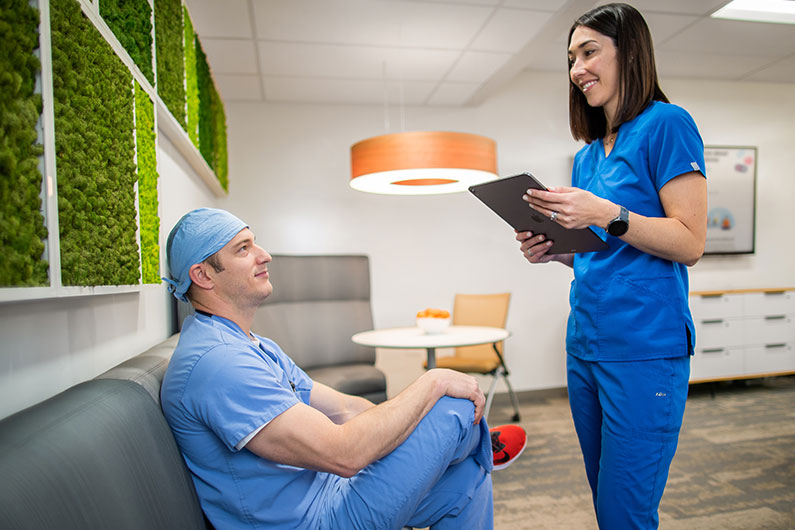 Male and female doctor talking to each other in Kaiser Residency suite