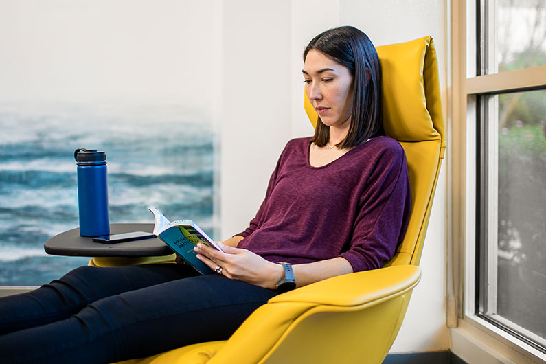 Close up of female sitting in chair at Kaiser Family Residency suite