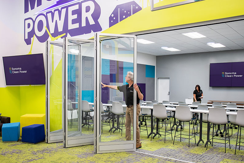 Man opening retractable doors at training classroom