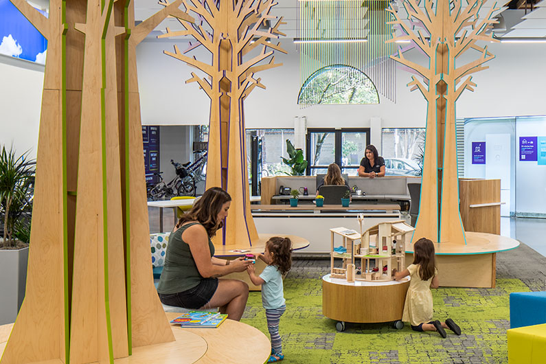 Mother and two children playing in the kids zone at Advanced Energy Center