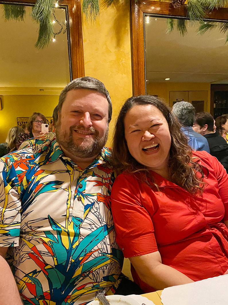 Man and woman smiling at TLCD holiday party