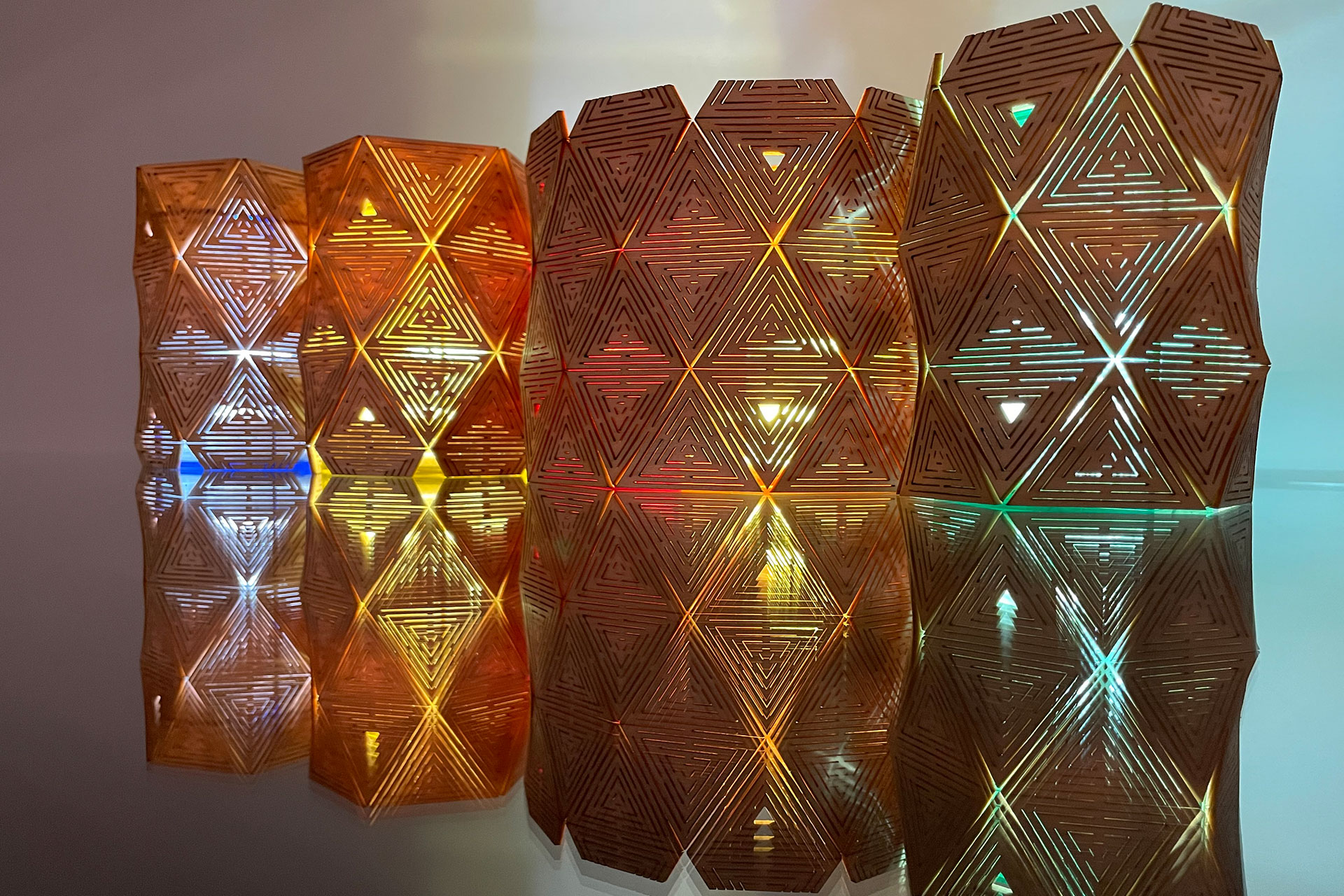 Laser cut lights in multiple colors with reflections on glass