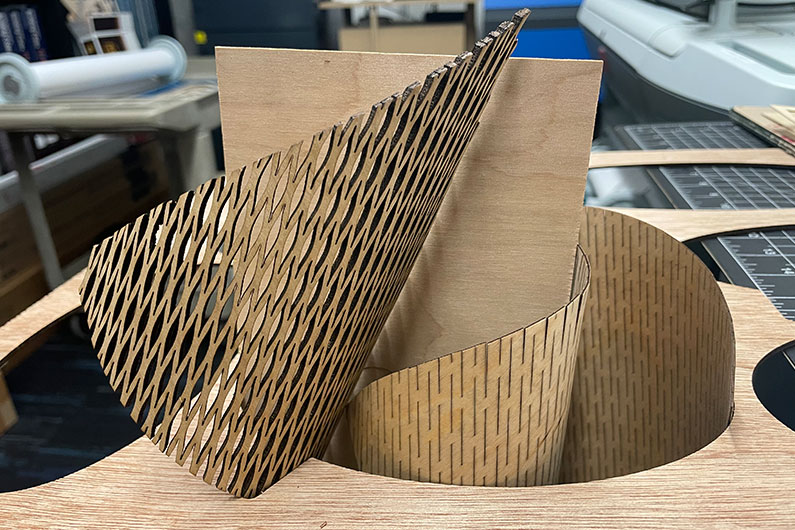 Closeup of laser cut plywood formed in shape of cones