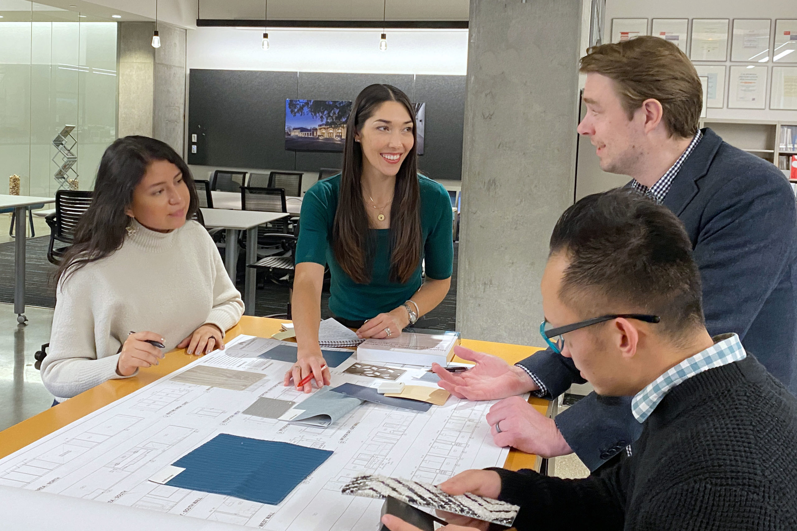 TLCD Principal Chelsea Hamada working with 3 people in architecture office