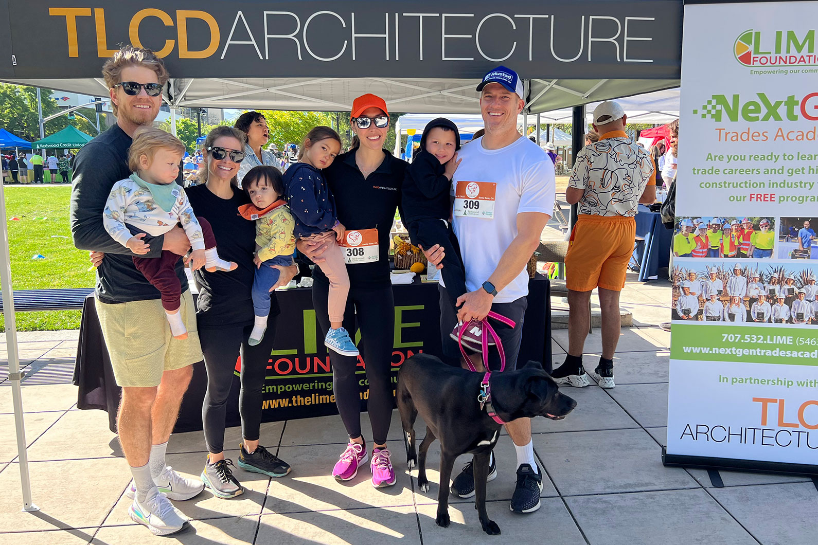 TLCD team and families standing in front of booth at Human Race