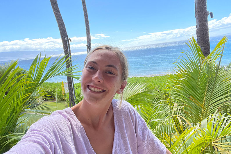 Kiely Rowe outdoors in Hawaii with ocean in background
