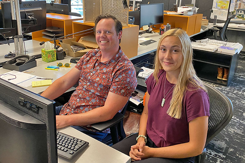 Kiely Rowe and Mitchell Price working at desk together