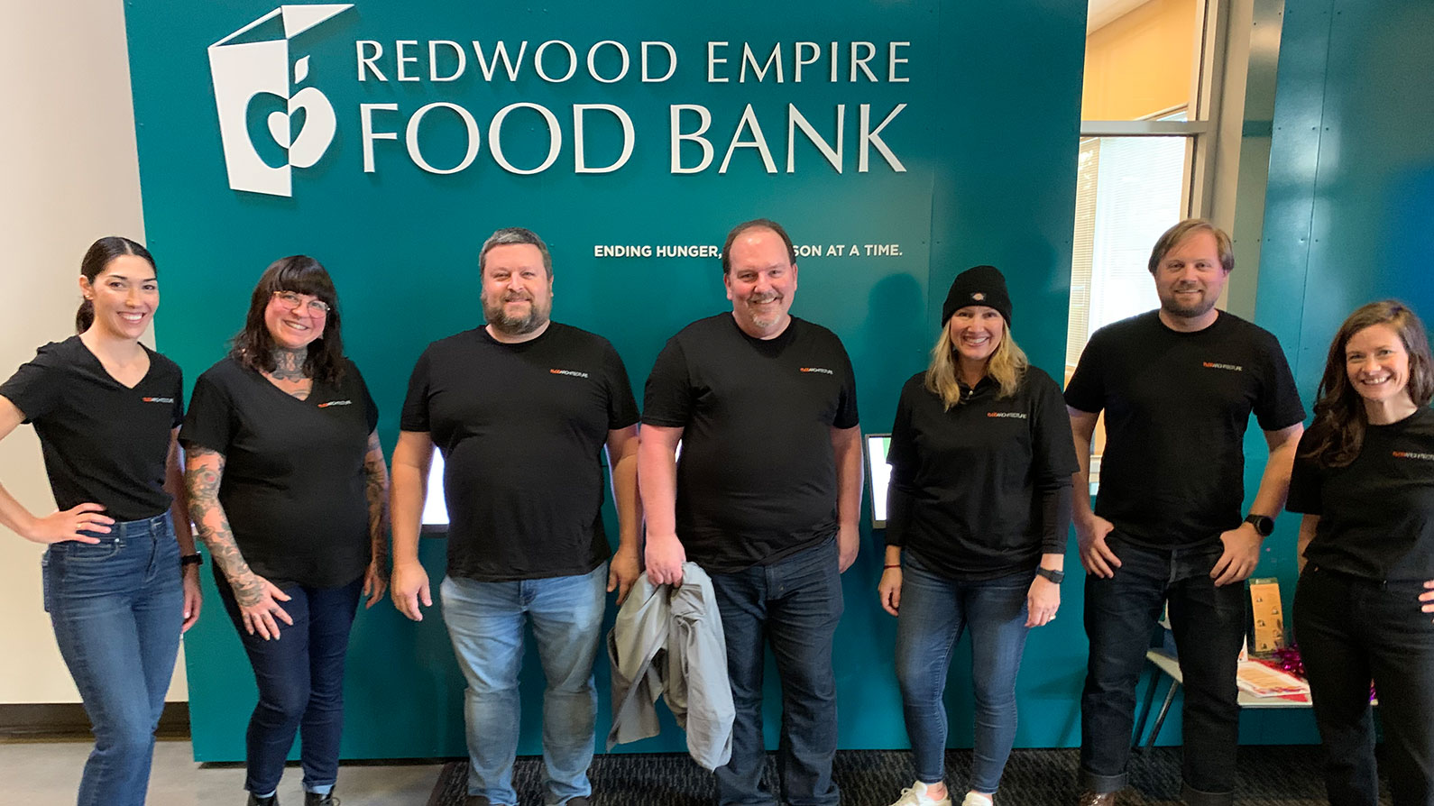 TLCD team lined up under sign at Redwood Empire Food Bank