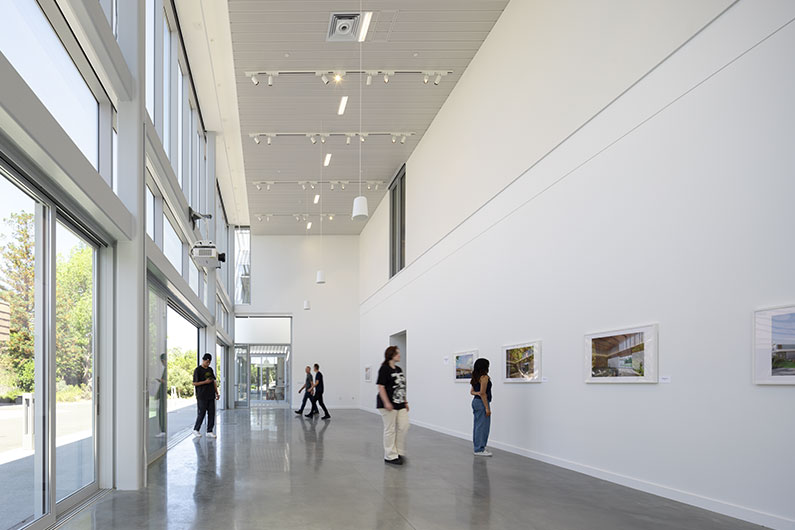 Photo of gallery space with high ceilings and natural indoor-outdoor connection at West Valley College Visual Arts Building