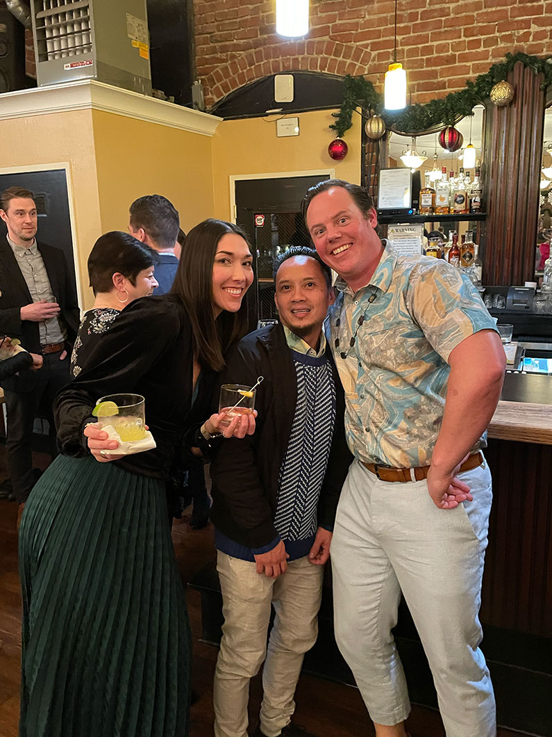 Woman and two men leaning in to cheese it for the camera