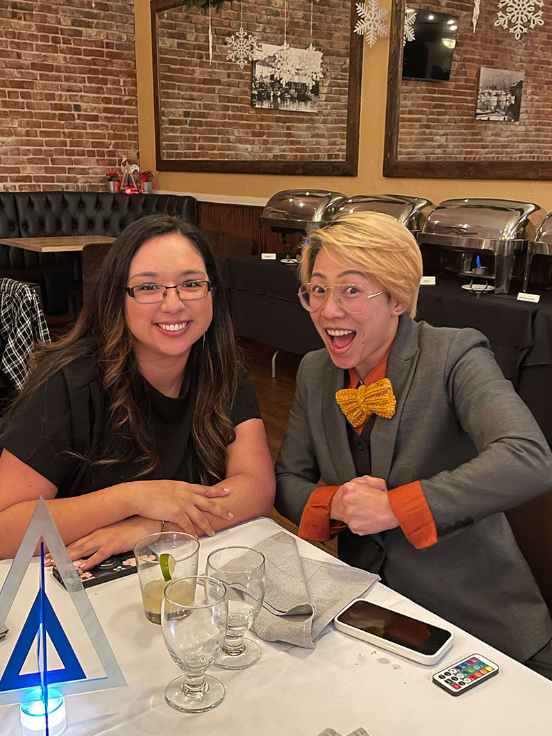 Two women smiling at TLCD holiday party