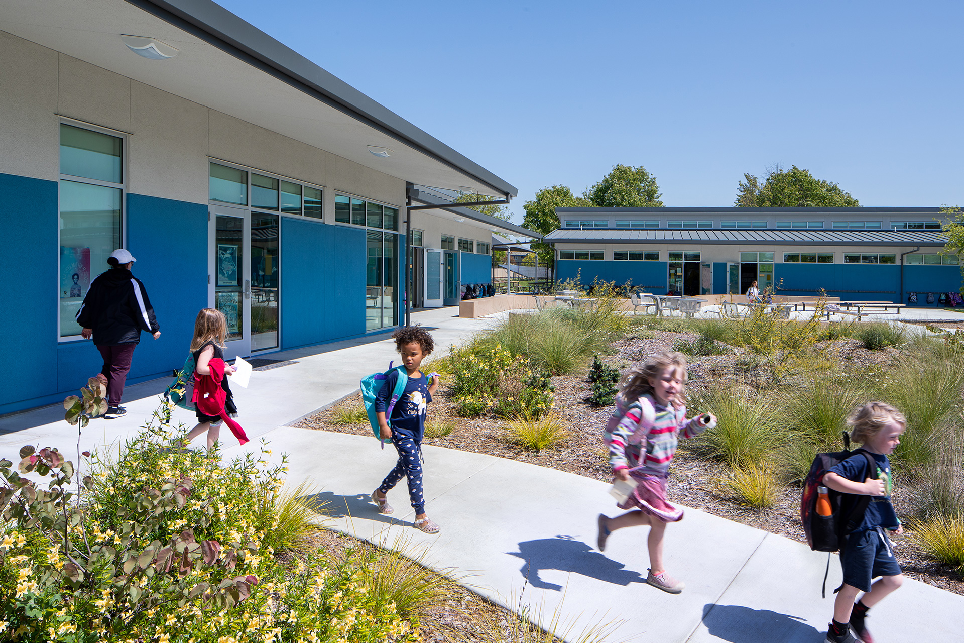 One teacher and 4 children shown outdoors on the Loma Vista Immersion Academy campus