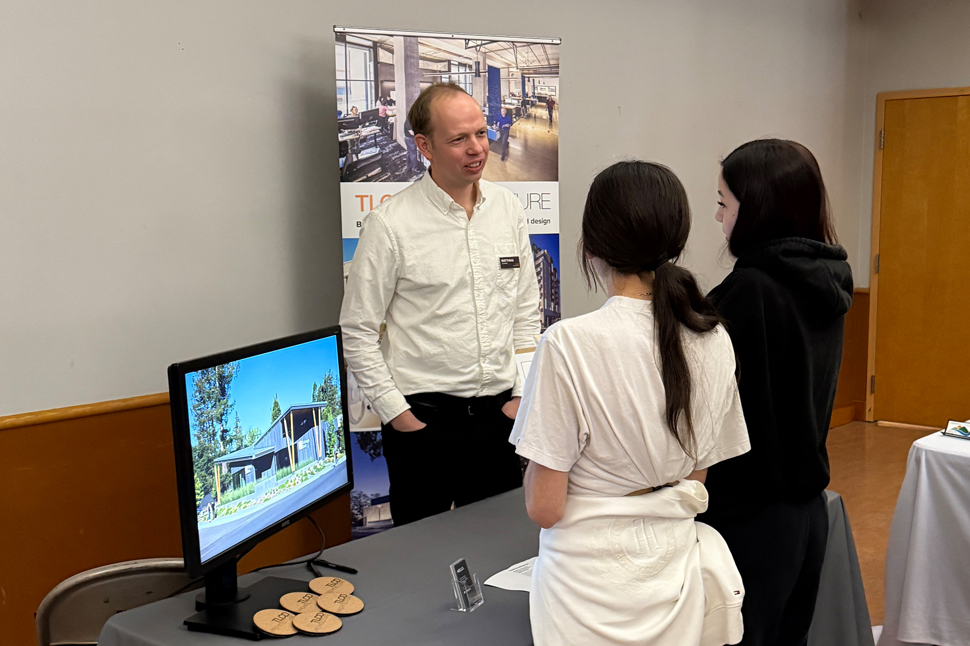 TLCD Project Captain, Matthias Schwarz talking to two students at Piner High School Career Fair