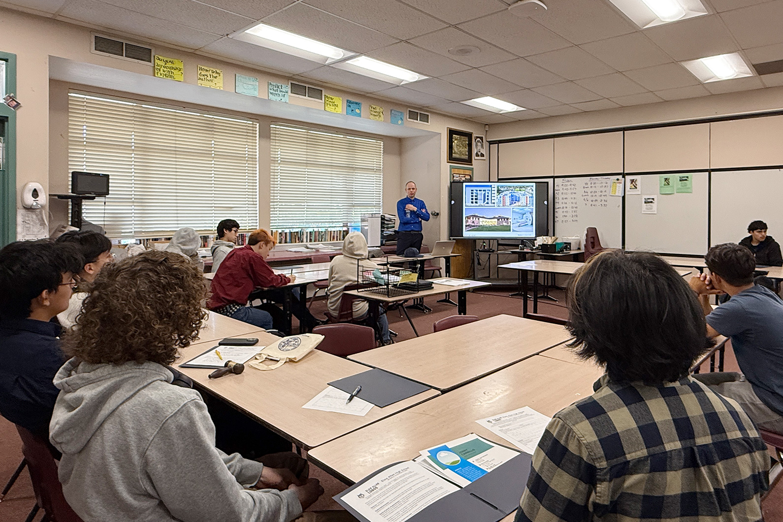 Students in classroom at Elsie Allen High School with Matthias Schwarz talking at front