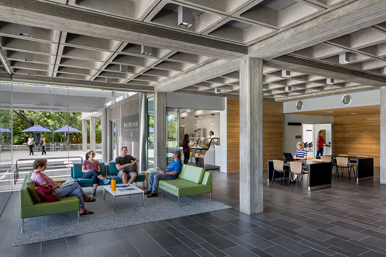 Interior photo of hang out space for students with cafe in background