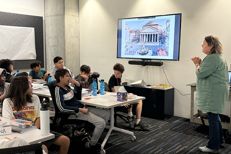 Architect presenting to Mike Hauser students at TLCD Architecture office conference room