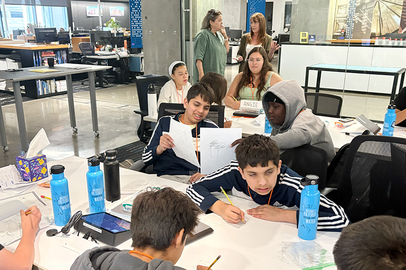 Group shot of students working on project -Mike Hauser STEM Academy