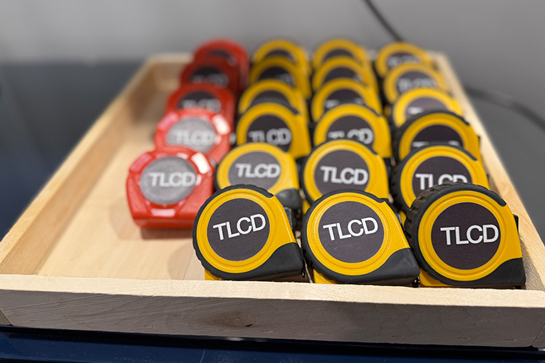 Close up photo of TLCD branded tape measures for student projects