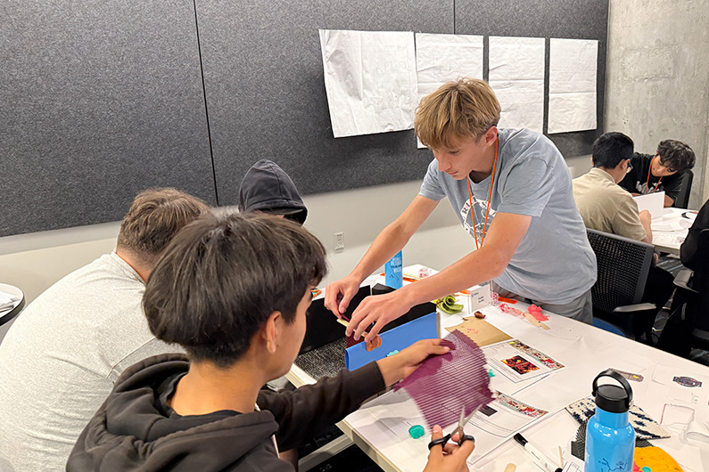 Group of 3 boys working on design project - Mike Hauser STEM Academy