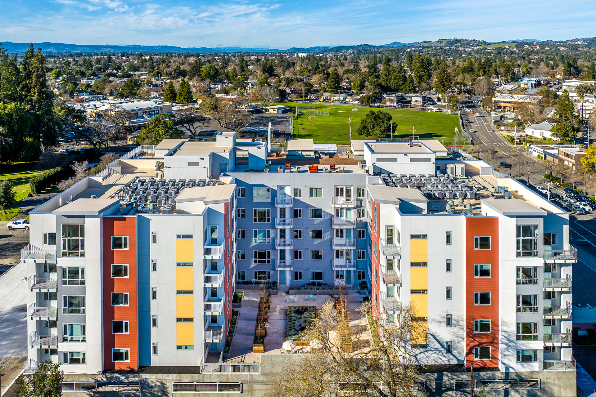 Drone photo of 888 Fourth Street project with surrounding Santa Rosa hills in background - Mutlifamily Architecture