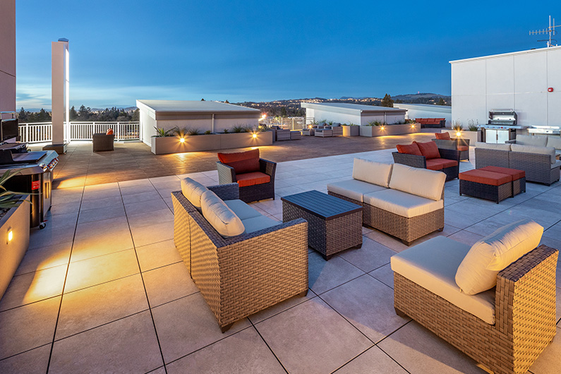 Exterior night photo of rooftop deck and lounge area at 888 Fourth Street, Multifamily Architecture