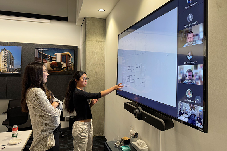 Jessica and Principal Chelsea Hamada talking during a design charette