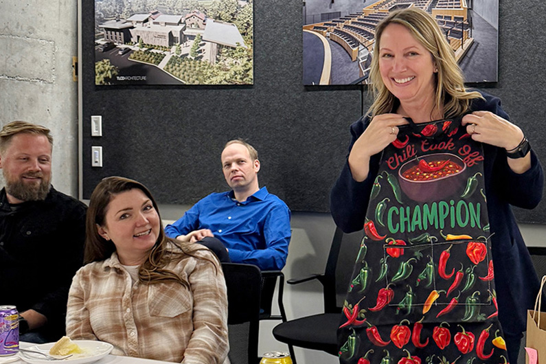 Heather Kahnberg, winner of the TLCD chili cookoff with other team members in the background