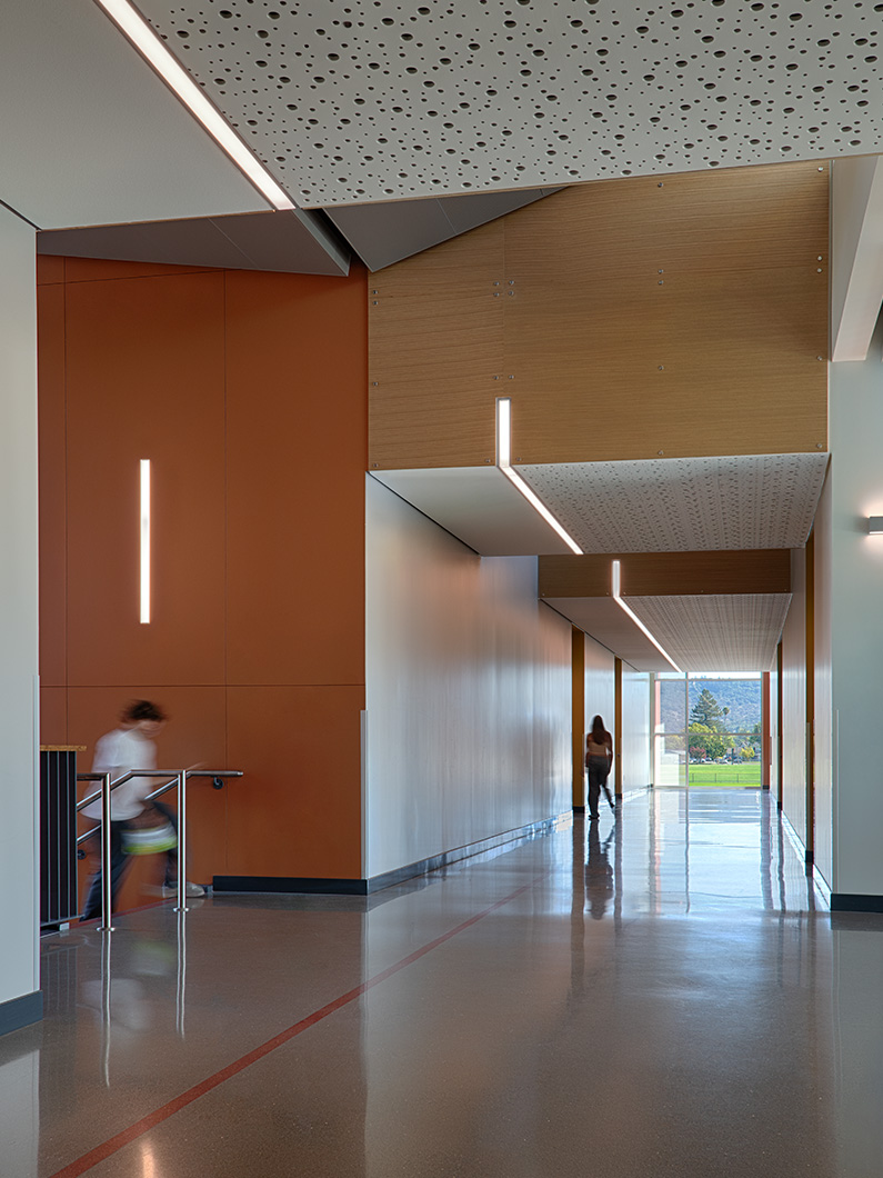 Interior photo shows details in ceiling lighting and flooring on both levels