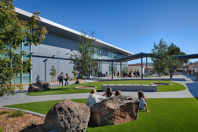 Exterior view of courtyard and walkway that connects campus to new building