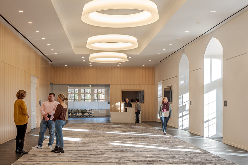 Interior photo of Burbank Auditorium's remodeling lobby with several people standing